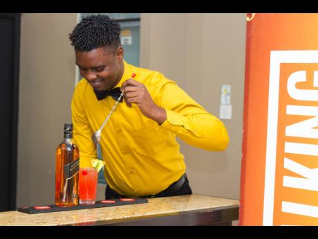 Food and beverage major and winner of the UTech/Johnnie Walker Mixology Face-off Shaquille Blair adds final touches to his second-round cocktail: the Johnnie Walker Caribbean Dream.