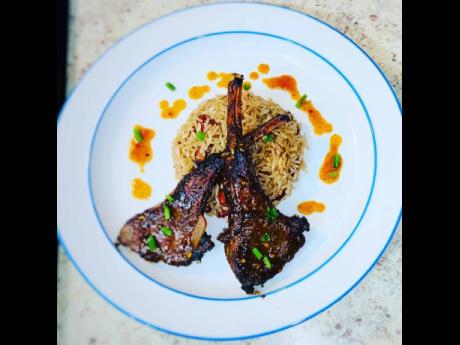 These jerked lamp chops, served on a bed of rice and peas, screams bon appétit!