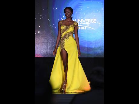 Calvin took the 2022 Miss Universe Jamaica title in this yellow Dermoth Williams gown. 