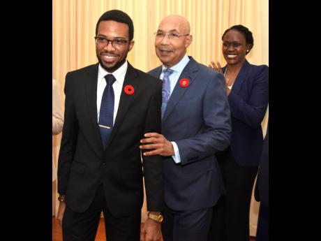 Sir Patrick Allen, governor general, presents David Salmon (left) as the 2023 Rhodes Scholar for Jamaica while Mariame McIntosh Robinson, secretary of the selection committee, joins in applause. Salmon topped 10 candidates.