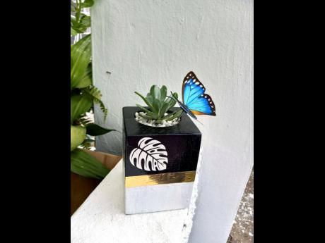 Branden-Hind brings art into the wooden planters with the added beauty element of the butterfly.