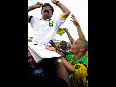 Technical Director Rene Simoes is hoisted after the Reggae Boyz drew with Mexico in their Concacaf final-round qualifier at the National Stadium in 1997, marking Jamaica’s qualification for the 1998 World Cup Finals in France. Looking on are Reggae Boyz 