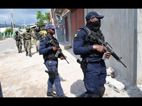 A joint security-force team patrolling a section of Olympic Gardens hours after Prime Minister Andrew Holness declared states of emergency in six parishes Tuesday.