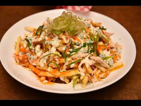 TGI Fridays’ new menu item, loaded Buffalo chicken fries: crispy seasoned fries, topped with pulled Buffalo chicken, bleu cheese crumbles, ranch dressing and melted cheddar cheese,and finished with green onions and shaved celery.
