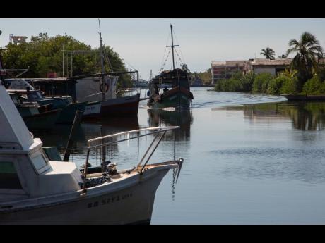 AP 
A boat arrives at the Surgidero de Batabano, where fishermen’s boats dock in Batabano, Cuba, on October 25. Cuba is suffering from longer droughts, warmer waters, more intense storms, and higher sea levels because of climate change.