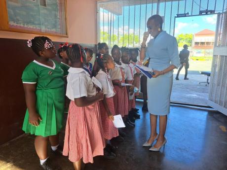 Portsmouth Primary School students interact with Education Minister Fayval Williams at a function to award them for excellence, held on November 16.