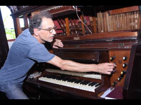 Friedemann Buschbeck examines the organ at the St James Parish Church in Montego Bay on Tuesday, November 15.