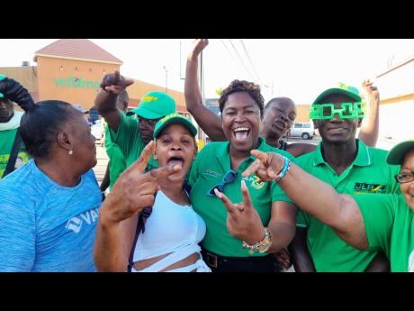 Tanyalee Williams (centre), councillor for the May Pen North division, with JLP supporters in Bargain Village, May Pen, Sunday morning. 