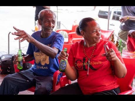 Homez Stennett (left) and Julian Myrie react during a World Cup viewing session at Sonia’s Place on the Terrace on Waltham Park Road Sunday. 