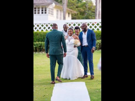 The beautiful bride was escorted up the aisle by her mother and two uncles. The bridal march team was met by the handsome groom who took his wife-to-be by the hand and carried her the rest of the way. 