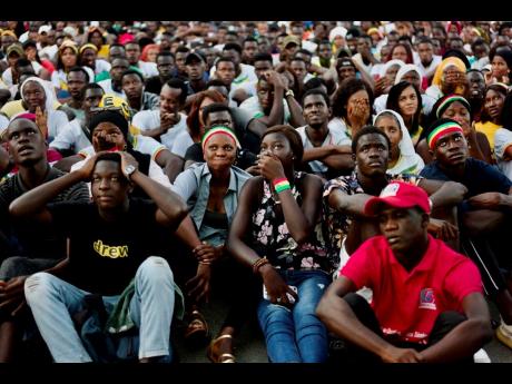 Senegal soccer fans react to Netherlands scoring as they watch their team on a large screen at a fan zone in the UCAD University in Dakar Monday. The Africans were beaten 2-0 in their World Cup Group B football match.