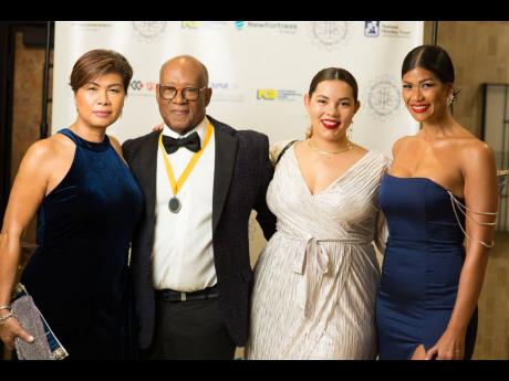 Left: Engineers Marvin Campbell (right), immediate past president, Jamaica Institution of Engineers, and wife Aisha Campbell, chief executive officer, PROVEN REIT, stuck to the dress code. 