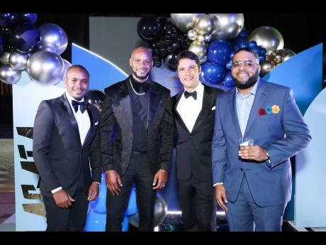 Asafa Powell (second left) and (from left), Kamal Powell, regional marketing manager, J. Wray & Nephew Ltd; Pietro Gramegna, marketing director; and Dominic Bell, brand public relations and communication manager.