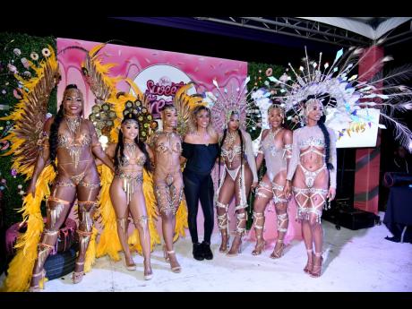 ‘Honey Dew’ and ‘Icy’ designer Jessica Campbell poses with her models during the Xodus band launch.