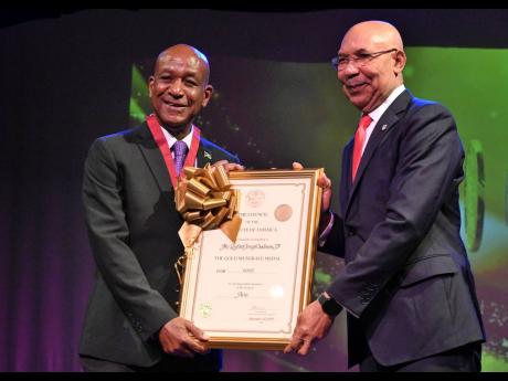 Cultural Engineer Lenford Salmon is honoured to receive his gold Musgrave medal from Sir Patrick Allen, governor general of Jamaica. 