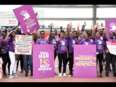 Protesters raise awareness in the fight against female victimisation during a Jamaica AIDS Support for Life-led silent protest to mark International Day for Elimination of Violence Against Women in the Half-Way Tree, St Andrew, on Friday.