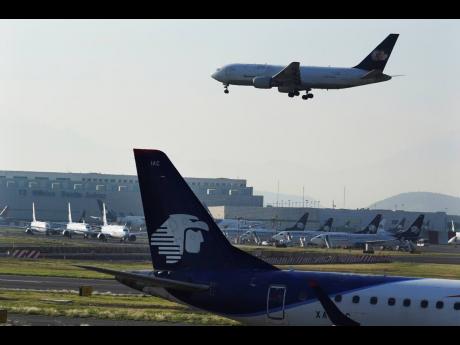 Passenger planes land at Benito Juárez International Airport in Mexico City, May 12, 2022.