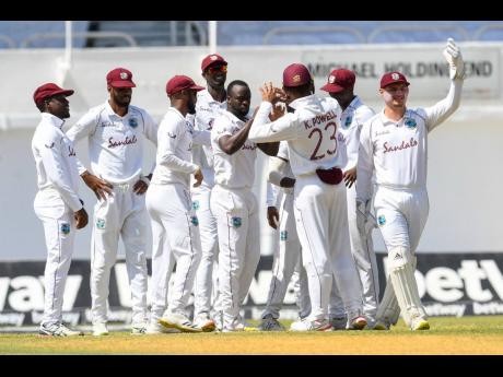 West Indies players celebrate the fall of a Pakistan wicket during a Test match at Sabina Park.  
