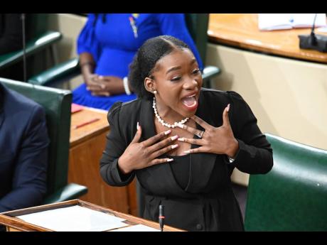 Patrina Stewart, deputy prime minister from St Mary South Eastern, addresses the 13th sitting of the National Youth Parliament of Jamaica at Gordon House in Kingston on Monday. Stewart lamented that squatting remained a major problem as enough affordable h
