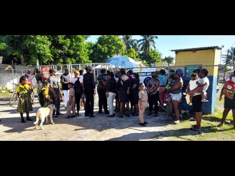 Teachers dressed in black at Homestead Primary and Infant are joined by parents as the staff staged a sit-out at the Spanish Town school on Tuesday. 