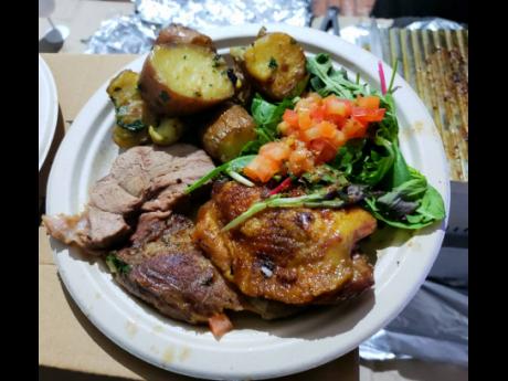 A small plate with mixed meats and provisions at the food village on Friday night.
