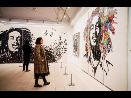 Images of the late reggae pioneer Bob Marley appear at the press launch for the exhibit ‘Bob Marley One Love Experience’ at the Saatchi Gallery in London on February 2. The multi-room exhibit will open at Ovation Hollywood in Los Angeles on January 27,