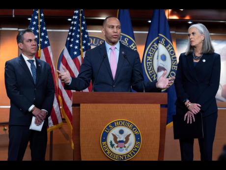 Representative Hakeem Jeffries (centre), joined by Representative Pete Aguilar and Representative Katherine Clark, speaks to reporters just after they were elected by House Democrats to form the new leadership when Speaker of the House Nancy Pelosi steps a