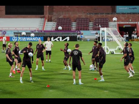 German players warm up during a training session at the Al-Shamal stadium on the eve of their Group E World Cup football match against Costa Rica, in Al-Ruwais, Qatar yesterday.