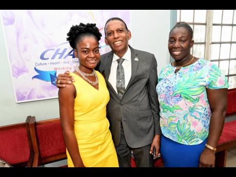 W. Billy Heaven, chief executive officer, the CHASE Fund, is flanked by Finance Manager Llewanna Simpson (left) and Office Attendant Keva Davis. 