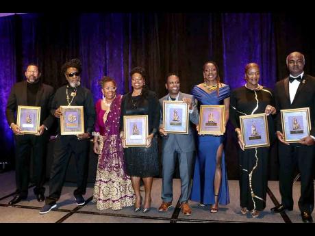 Caribbean American Heritage awardees from left: Ainsley Gill, Derrick ‘Duckie’ Simpson, Dr. Clare Nelson, president of the Caribbean Institute, Stacey Mollison, Dwight Smith, Josanne Francis, Professor Carol Davis and Biharil Lall, display their awards