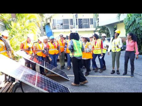 Lauren Peters, managing director of Nuance Security and Solar Systems Ltd, guides the 19 women during the Soleco Energy Limited-hosted training seminar held from November 7 to 10 as part of the latter company’s efforts to promote the inclusion of more wo
