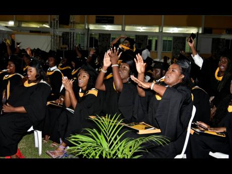 Graduates of the Mico University College celebrate during their graduation ceremony on Thursday.