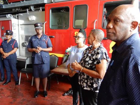Councillor Lydia Richards (third left) offer words of support to firefighters at the Ocho Rios Fire Station in St Ann on Friday as she and fellow councillors from the municipal corporation visited the grieving staff. Also pictured are (from left) Assistant