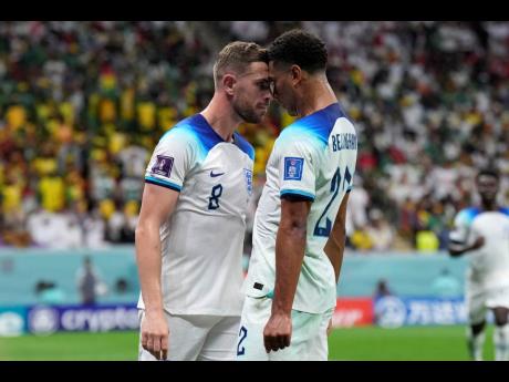 England's Jordan Henderson (left) celebrates with his teammate Jude Bellingham after scoring their first goal during the World Cup round of 16 football against Senegal, at the Al Bayt Stadium in Al Khor, Qatar today. England won 3-0.