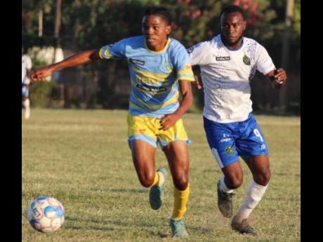 Waterhouse’s midfielder Shemar Boothe gets away from the pressing Bebeto McDonald of Vere United during their Jamaica Premier League (JPL) encounter at the Wembley Centre of Excellence today. Waterhouse won 1-0.