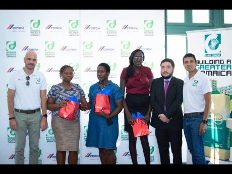 Yago Castro (left), managing director of Caribbean Cement Company Limited, with (from second left) Amerilis Cain, Sandrean Bailey, and Abigail Grant, who are participants of the cement company’s employment workshop for persons with disabilities. Others a