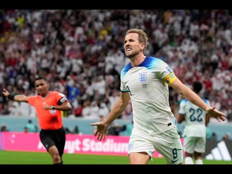 England’s Harry Kane celebrates after scoring his side’s second goal during the World Cup round of 16 match between England and Senegal at the Al Bayt Stadium in Al Khor, Qatar yesterday.