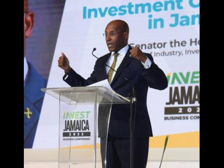 Aubyn Hill, minister of industry, investment and commerce, addresses the audience on the opening day of  the Invest Jamaica 2022 Business Conference at the Montego Bay Convention Centre on Tuesday.