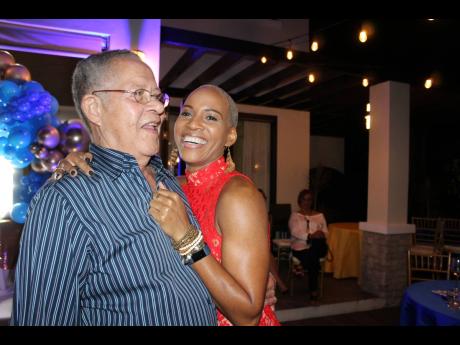 Daddy’s girl, Ann-Merita Golding, cuddles up to her father, Bruce Golding.