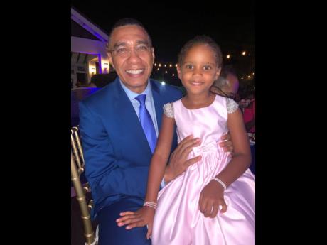 Prime Minster Andrew Holness obliges cutie pie Lyle-Kristina Turner with a picture.
