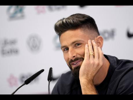 France’s Olivier Giroud smiles during a press conference at the Jassim Bin Hamad stadium in Doha, Qatar, yesterday.