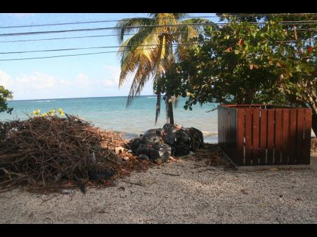 Garbage left behind from a clean-up project carried out on the Old Steamer Beach in Hopewell, Hanover, lay conspicuously beside a new dumpster built as part of the same project. The TEF is claiming that it is the World Bank that carried out the project, wh