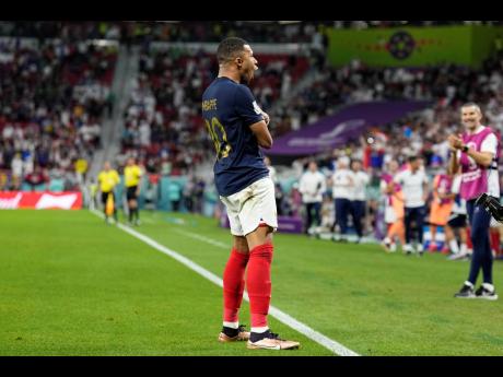 France’s Kylian Mbappé celebrates scoring his side’s third goal during the World Cup round of 16 football match against Poland at the Al Thumama Stadium in Doha, Qatar, on Sunday.