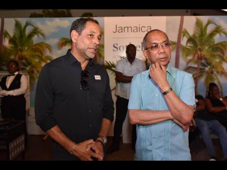 Marc Melville (left) of Chukka Adventures speaks with Deputy Prime Minister Horace Chang at the launch.