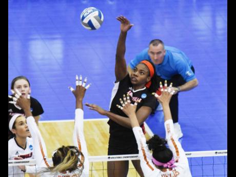 Aiko Jones (third right) goes high to make a play during the Cardinals’ NCAA Sweet 16 match against Texas in Austin last December.