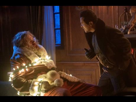 David Harbour (left), and John Leguizamo in a scene from ‘Violent Night’.
