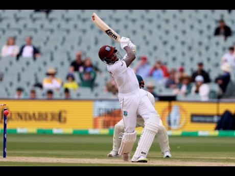 Left: The West Indies’ Alzarri Joseph is bowled by Australia’s Nathan Lyon on the fourth day of the second Test in Adelaide yesterday.