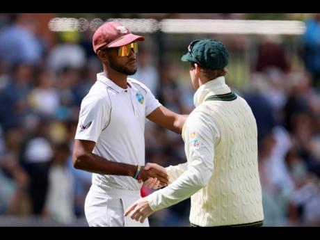 Above: West Indies captain Kraigg Brathwaite (left) shakes hands with Australia’s Steve Smith after Australia won the second Test match in Adelaide, Australia, yesterday.