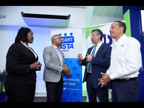 From left: Dionne Nugent, chairman of the eDrive Project Steering Committee; Michael McMorris, president, Jamaica Chamber of Commerce; Roberto Aiello, principal, Regional Energy Specialist, IDB Lab; and Gary Barrow, chief operating officer, JPS, conversing