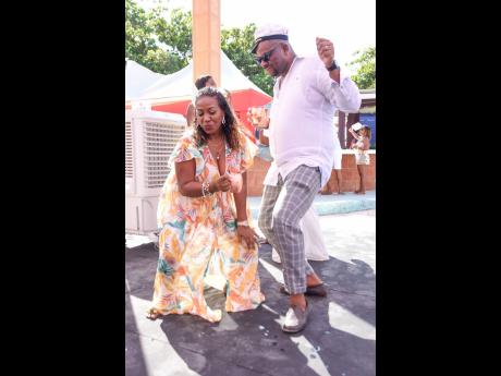 Karelle McKenzie, senior investment manager, Scotia Investments Jamaica Limited, and Eelon Grant, manager, Scotiabank, Santa Cruz branch, jam to the soca beat.